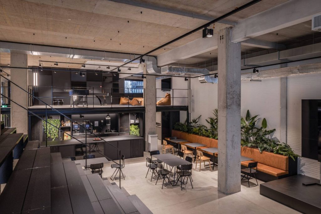 Grand espace de restauration avec vue sur la mezzanine au dessus et son espace détente.
