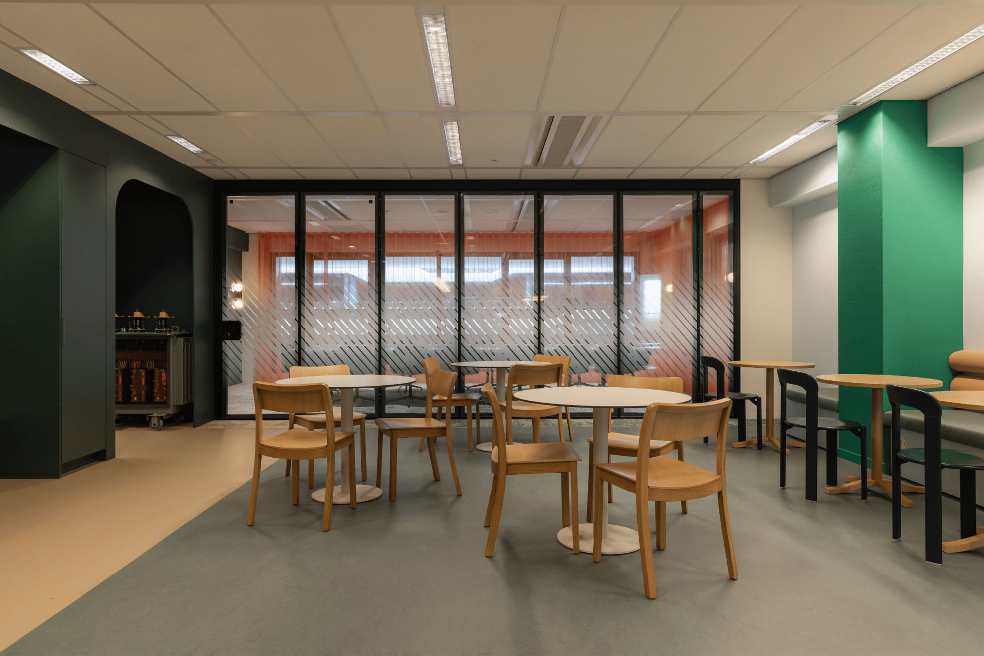 Photo de l'espace de restauration avec la cloison coulissante en place avec vitrophanie pour la salle de réunion.